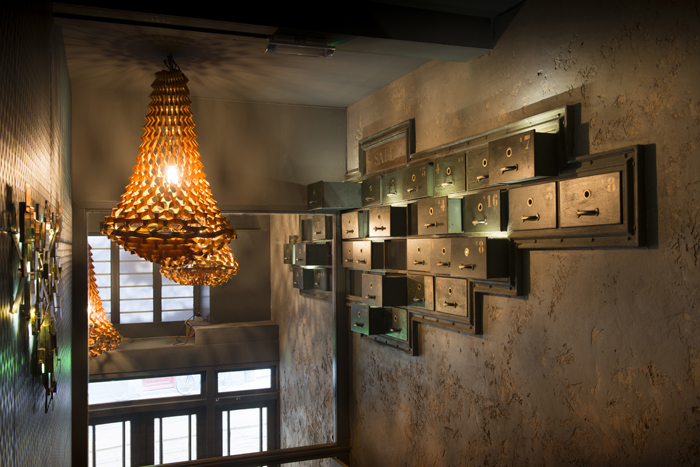 A large segment of antique safe-deposit lockers as an ornament, hovering high over the stairs in the lobby.